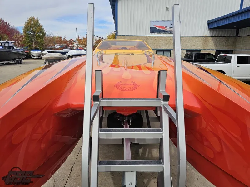 Slide: The Image of 2008 Eliminator 36 Daytona Coupe in vibrant orange, displayed outdoors with a ladder for access. - 31