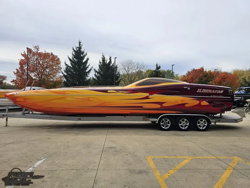 Slide: The Image of 2008 Eliminator 36 Daytona Coupe boat with vibrant flame design on a trailer. - 35