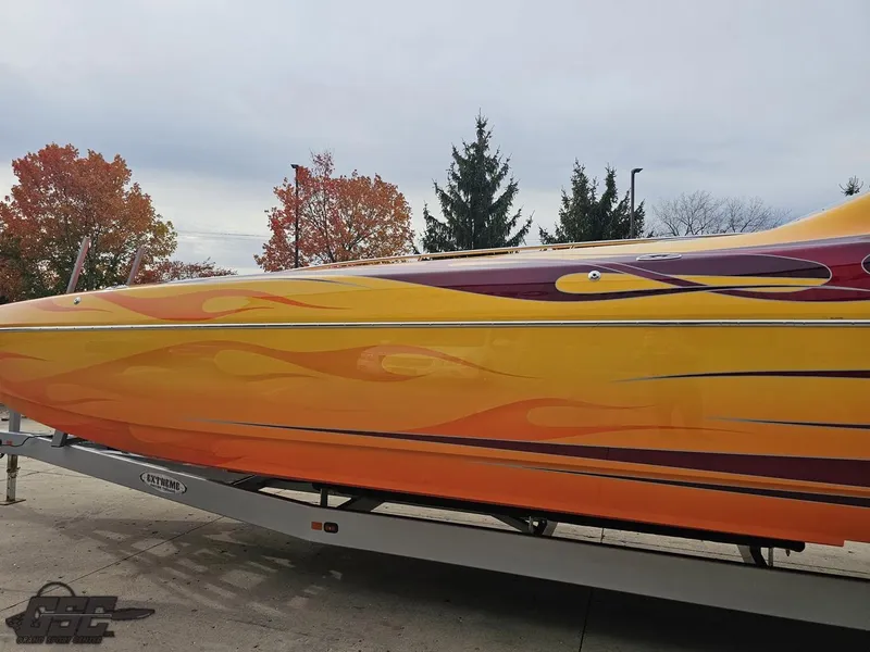 Slide: The Image of 2008 Eliminator 36 Daytona Coupe with vibrant flame design on trailer. - 36