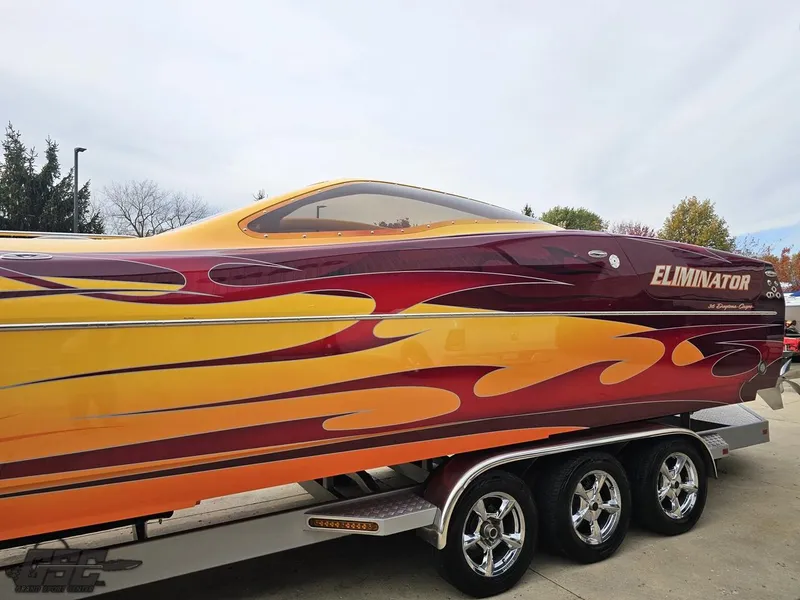 Slide: The Image of 2008 Eliminator 36 Daytona Coupe with vibrant flame design on a trailer. - 37