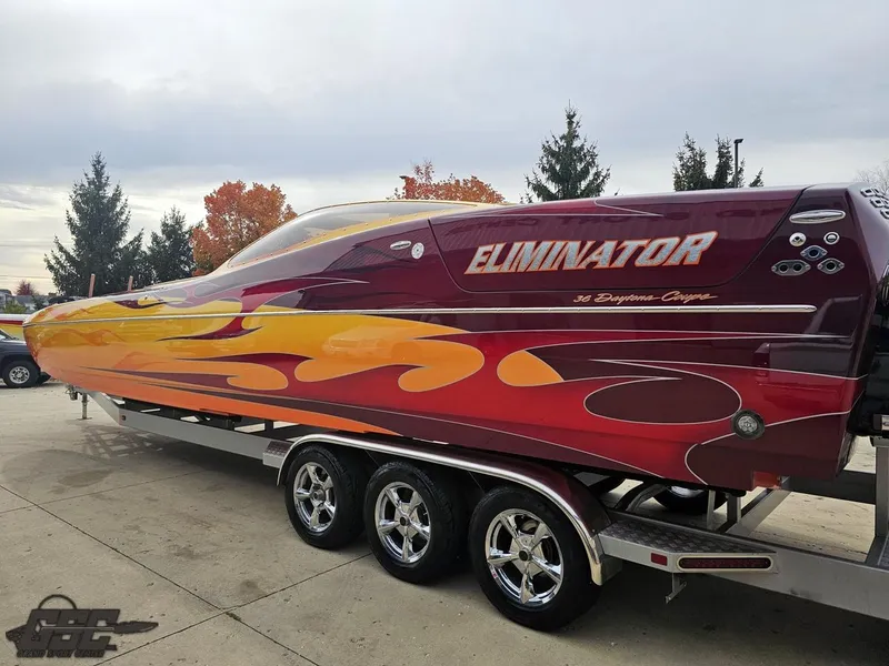 Slide: The Image of 2008 Eliminator 36 Daytona Coupe boat with vibrant flame design on a trailer. - 40