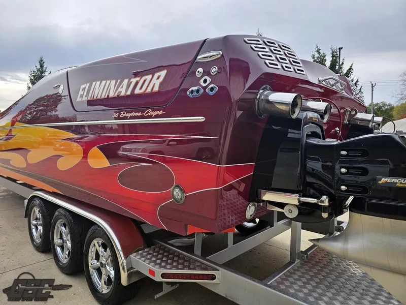 Slide: The Image of 2008 Eliminator 36 Daytona Coupe speedboat with vibrant flame design on a trailer. - 42