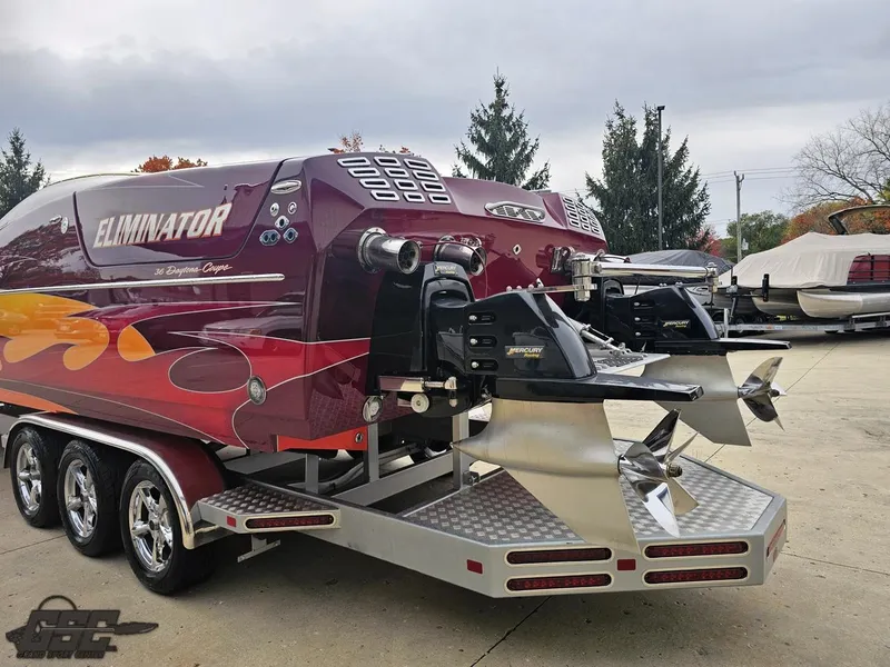 Slide: The Image of 2008 Eliminator 36 Daytona Coupe boat with vibrant graphics and powerful dual propellers. - 43