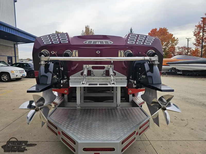 Slide: The Image of 2008 Eliminator 36 Daytona Coupe boat with dual propellers, parked outdoors. - 46