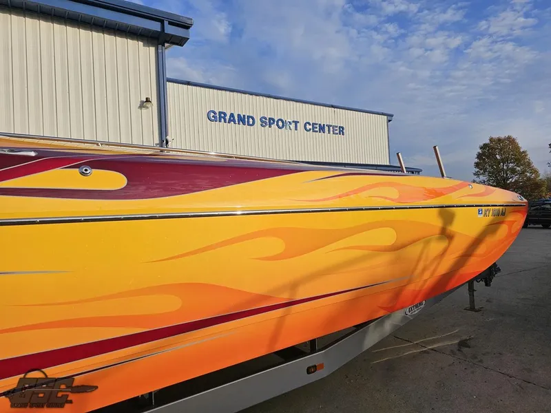 Slide: The Image of 2008 Eliminator 36 Daytona Coupe with vibrant flame design at Grand Sport Center. - 6