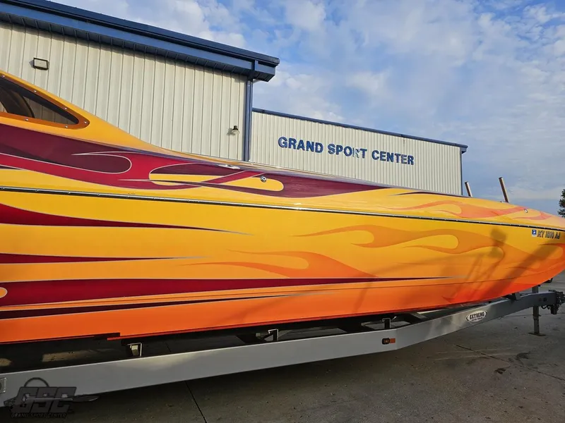 Slide: The Image of 2008 Eliminator 36 Daytona Coupe with vibrant flame design at Grand Sport Center. - 7