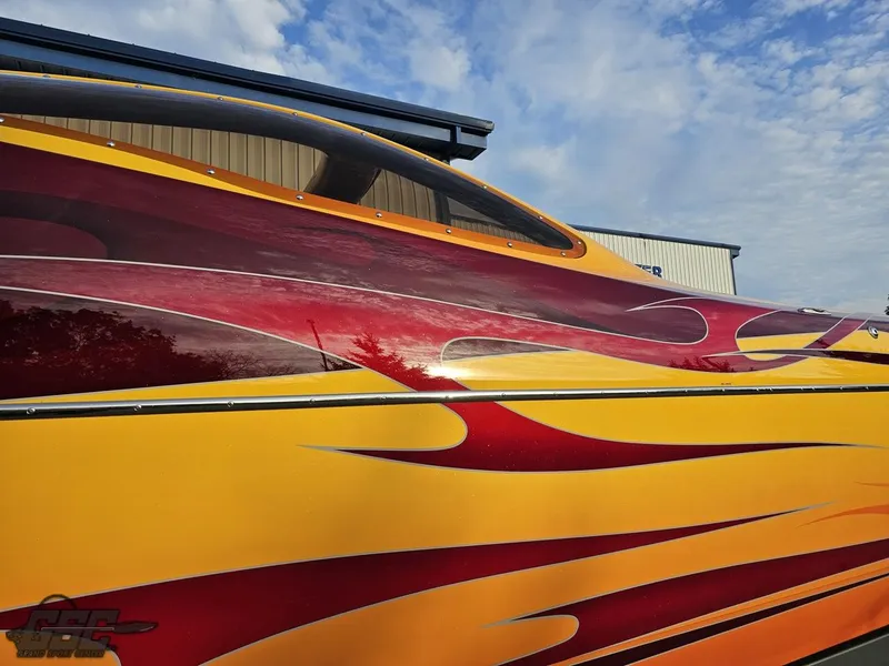Slide: The Image of 2008 Eliminator 36 Daytona Coupe with vibrant red and yellow flame design. - 8