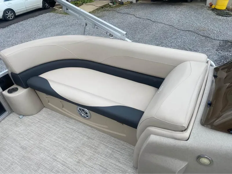 Slide: The Image of 2017 Avalon GS2185 boat interior with beige and black seating, cup holder, and speaker. - 6
