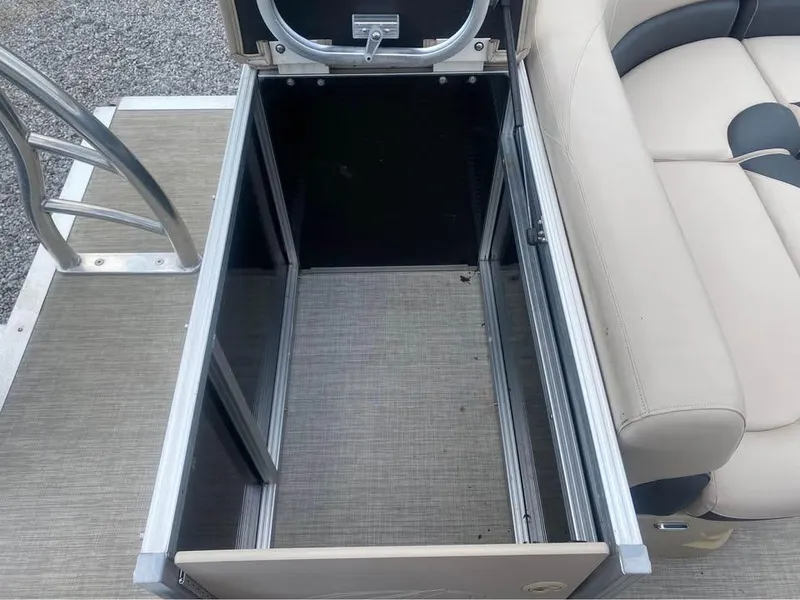 Slide: The Image of Open storage compartment on 2017 Avalon GS2185 boat with beige seating. - 8