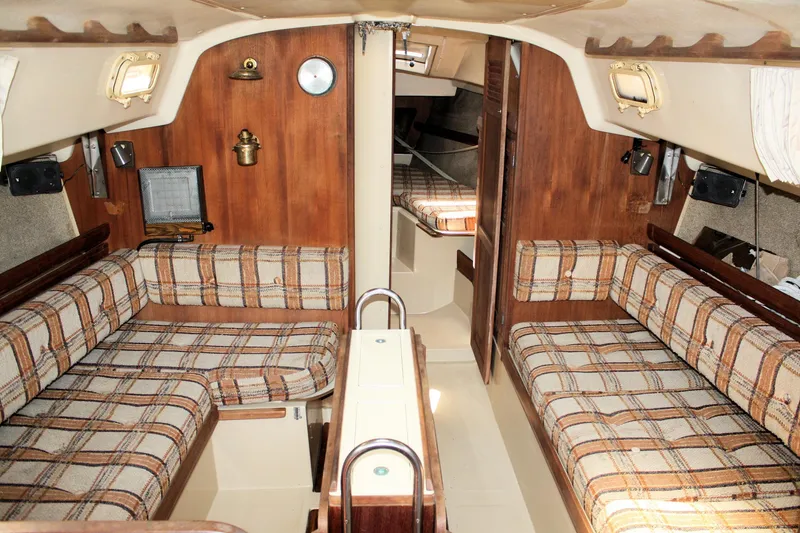 Slide: The Image of Interior of 1981 O'Day 34 sailboat with plaid seating and wooden accents. - 13