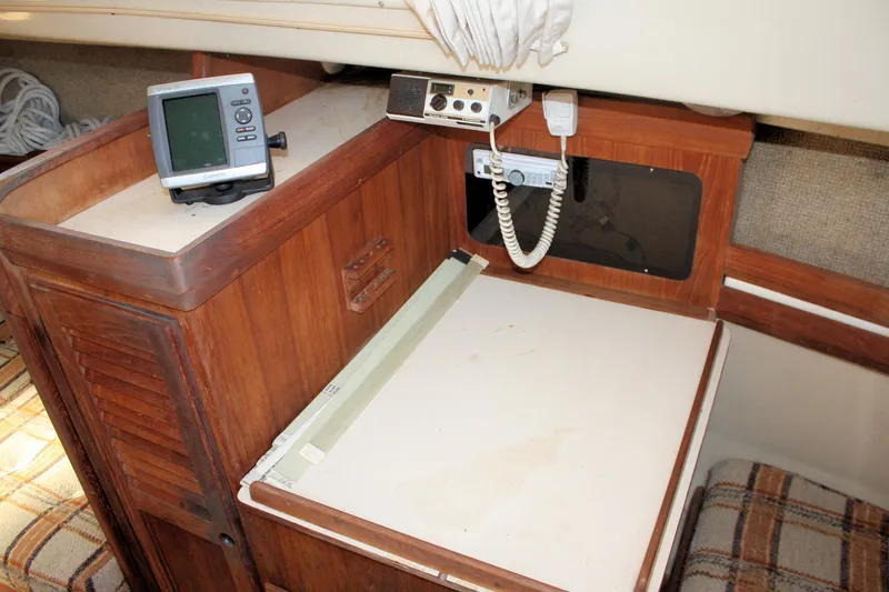 Slide: The Image of 1981 O'Day 34 sailboat interior with navigation equipment and wooden cabinetry. - 15
