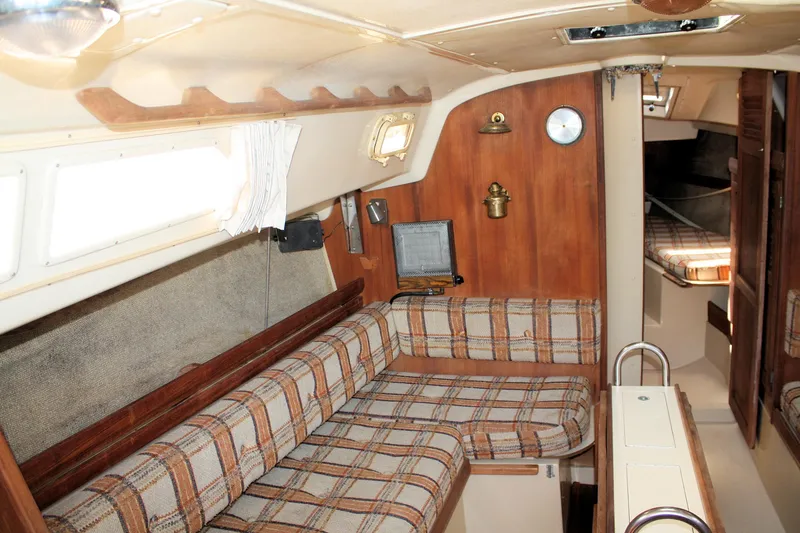 Slide: The Image of Interior of 1981 O'Day 34 sailboat with plaid seating and wooden accents. - 16