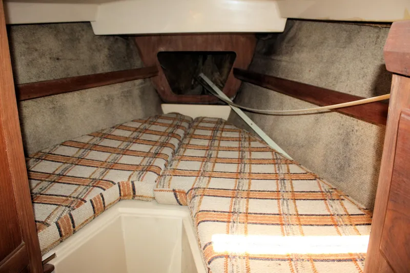 Slide: The Image of Interior cabin of 1981 O'Day 34 sailboat with plaid cushions and wooden accents. - 18