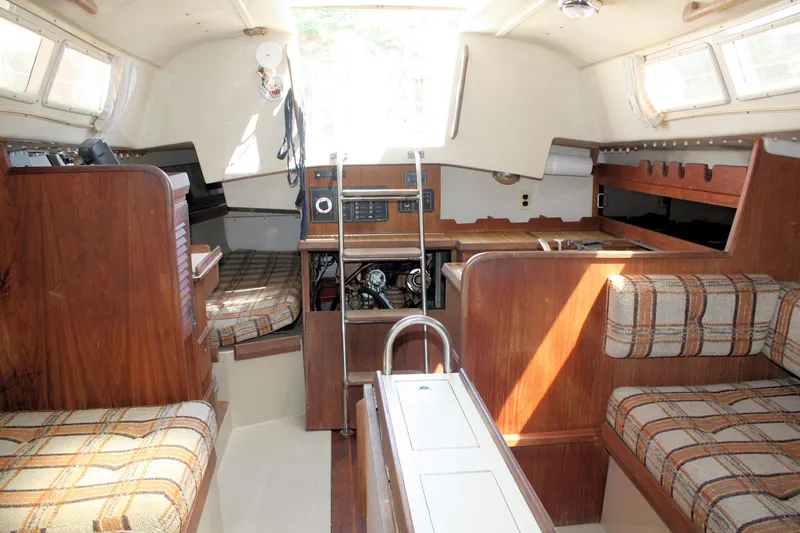 Slide: The Image of Interior of 1981 O'Day 34 sailboat with wood paneling and plaid seating. - 21
