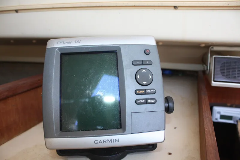 Slide: The Image of Garmin GPSmap 541 device on 1981 O'Day 34 sailboat, wooden interior background. - 32