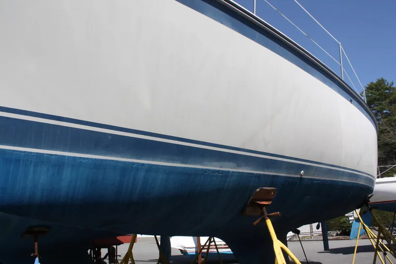 Slide: The Image of 1981 O'Day 34 sailboat hull on stands, blue and white exterior. - 4