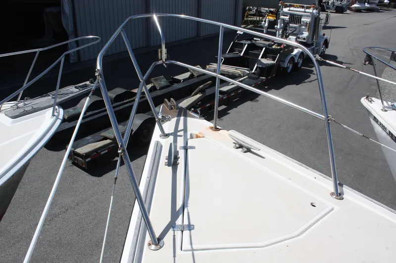 Slide: The Image of 1981 O'Day 34 sailboat deck with metal railings and trailer in background. - 5