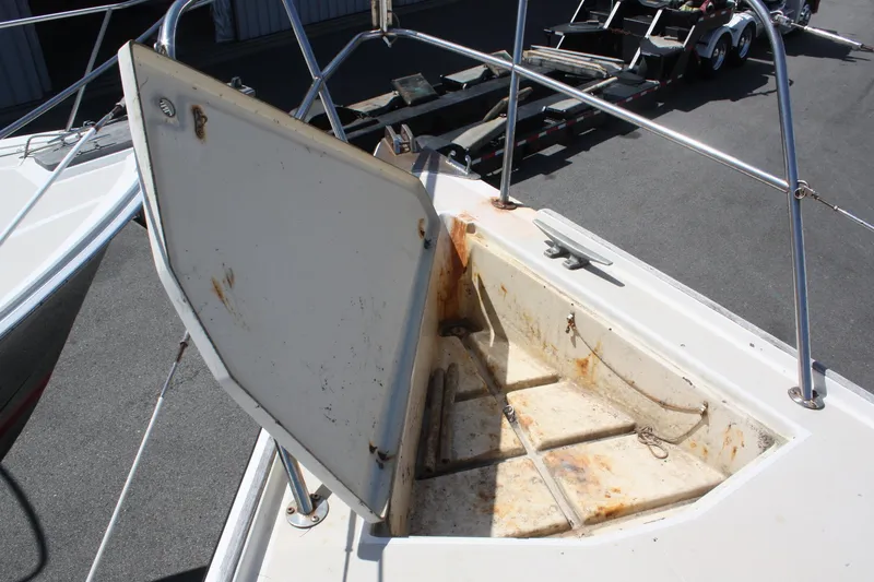 Slide: The Image of Open storage compartment on 1981 O'Day 34 sailboat deck, showing wear and rust. - 6