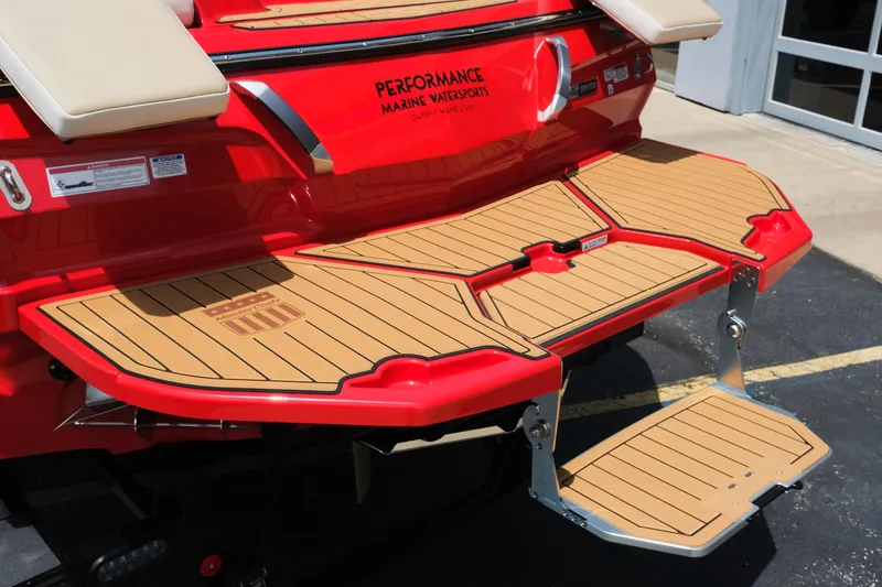 Slide: The Image of 2025 MasterCraft X24 boat with teak swim platform and fold-down step. - 10