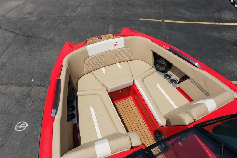 Slide: The Image of 2025 MasterCraft X24 boat interior with red and beige seating, featuring modern design and comfort. - 26