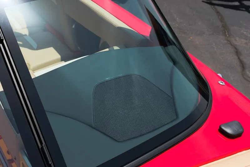 Slide: The Image of 2025 MasterCraft X24 boat interior with red and beige seating, viewed through windshield. - 28