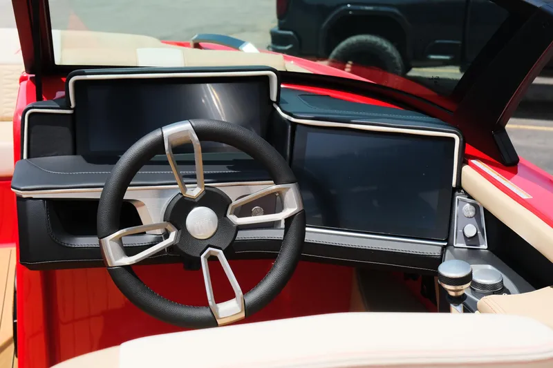 Slide: The Image of 2025 MasterCraft X24 boat dashboard with modern steering wheel and digital displays. - 30
