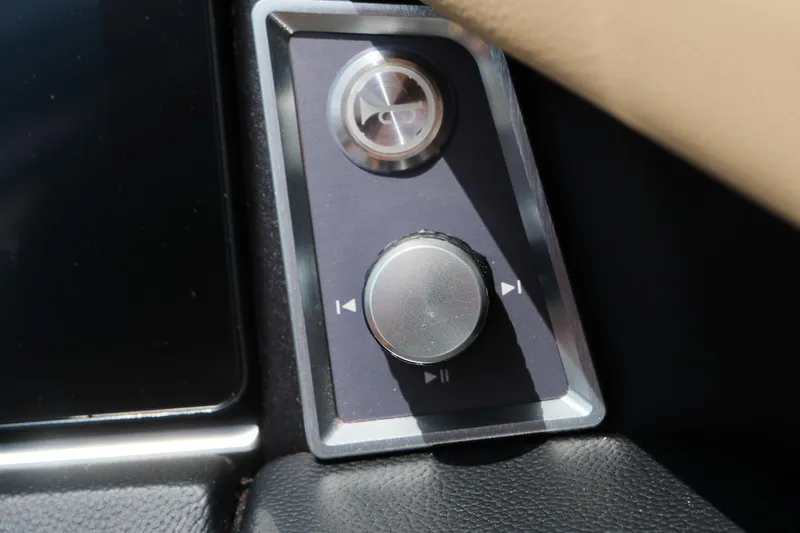 Slide: The Image of Control panel of 2025 MasterCraft X24 boat with buttons and dial. - 32