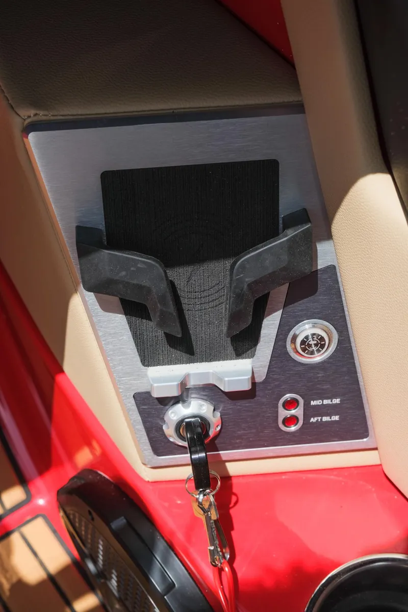 Slide: The Image of Control panel of 2025 MasterCraft X24 boat with key ignition and switches. - 34