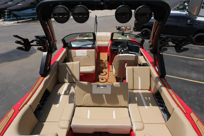 Slide: The Image of 2025 MasterCraft X24 boat interior with beige seating and advanced audio system. - 36