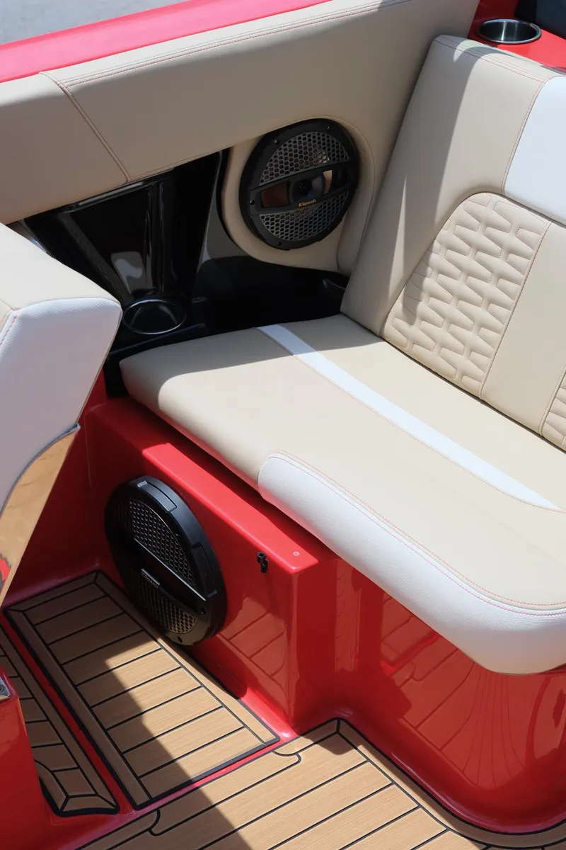 Slide: The Image of 2025 MasterCraft X24 boat interior with beige seating and red accents. - 40