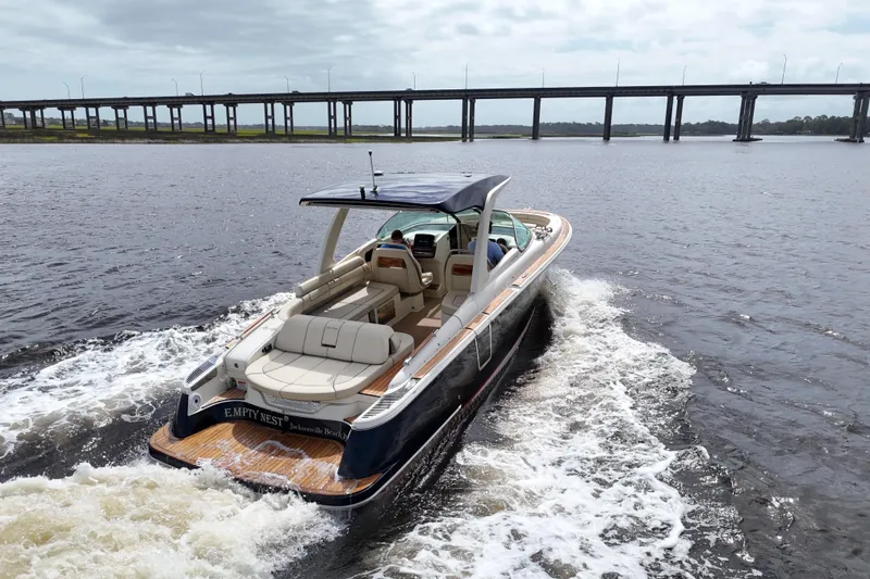 Slide: The Image of 2020 Chris-Craft Launch 31 GT cruising on water near a bridge. - 100
