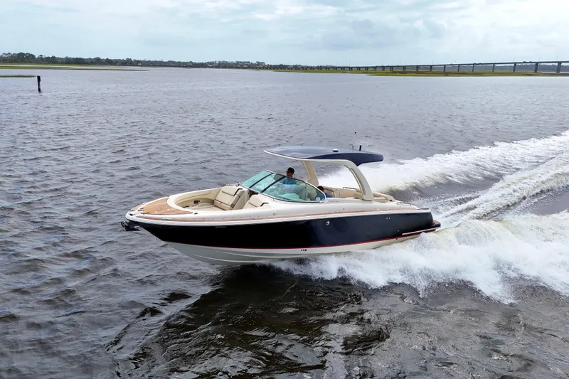 Slide: The Image of 2020 Chris-Craft Launch 31 GT cruising on open water, showcasing sleek design and performance. - 105