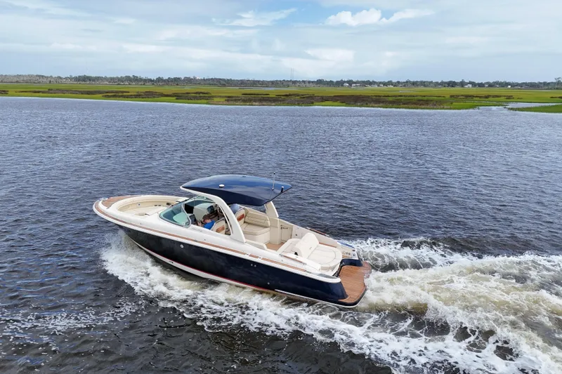 Slide: The Image of 2020 Chris-Craft Launch 31 GT cruising on a scenic waterway. - 106