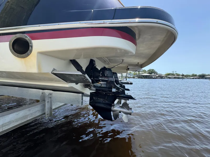 Slide: The Image of 2020 Chris-Craft Launch 31 GT boat stern and propeller, docked by the water. - 110