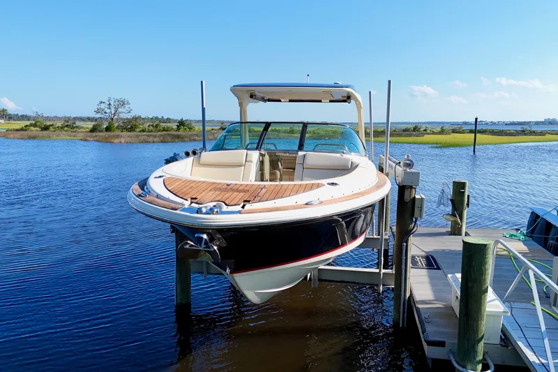 Slide: The Image of 2020 Chris-Craft Launch 31 GT cruising on open water under a clear sky. - 2