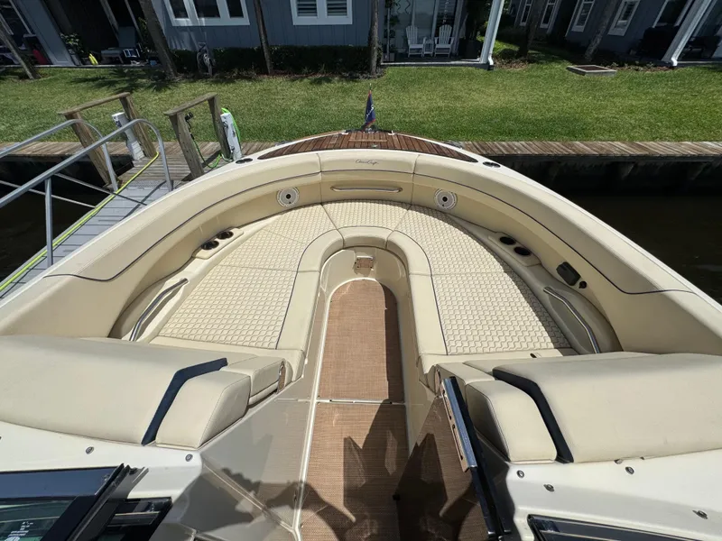 Slide: The Image of 2020 Chris-Craft Launch 31 GT boat interior with American flag, luxury seating, and wooden deck. - 61