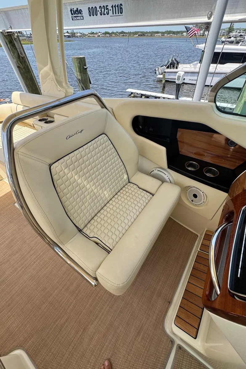 Slide: The Image of 2020 Chris-Craft Launch 31 GT boat with beige cushioned seating and cup holders. - 63