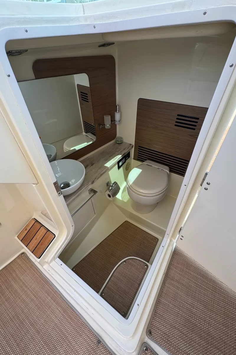 Slide: The Image of 2020 Chris-Craft Launch 31 GT boat roof with hydraulic supports against clear sky. - 66