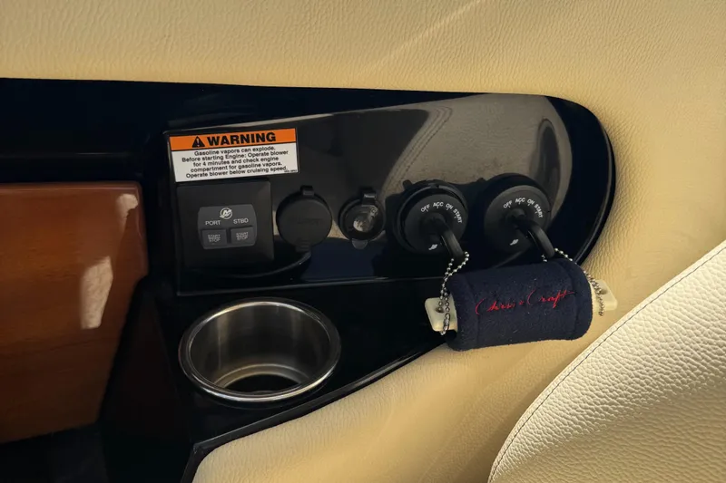 Slide: The Image of Control panel of 2020 Chris-Craft Launch 31 GT with ignition keys and cup holder. - 76