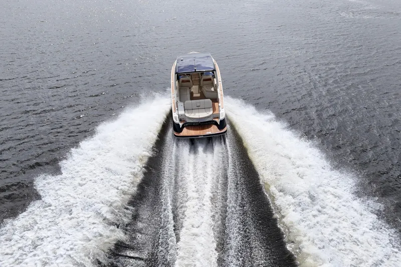Slide: The Image of 2020 Chris-Craft Launch 31 GT boat cruising on open water, rear view. - 98