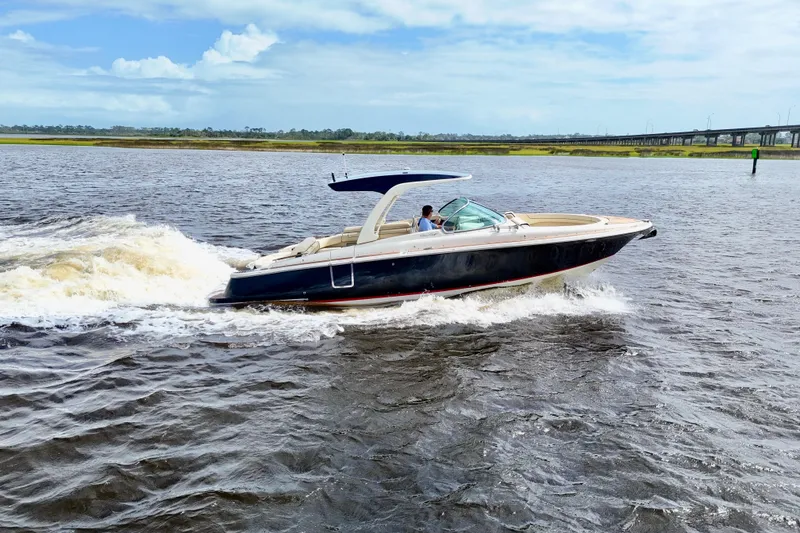 Slide: The Image of 2020 Chris-Craft Launch 31 GT cruising on a sunny day, showcasing sleek design and performance. - 99