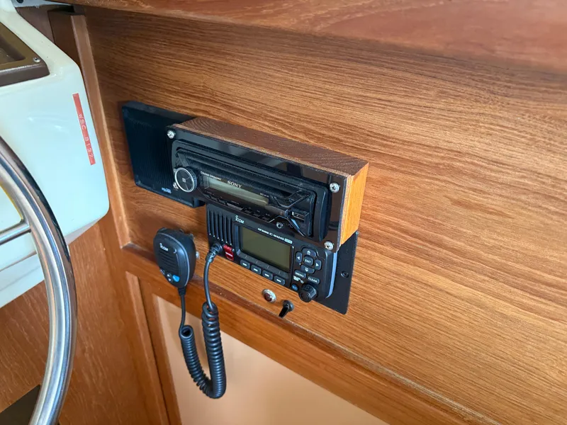 Slide: The Image of 1985 Trojan F36 boat dashboard with radio and communication equipment. - 11