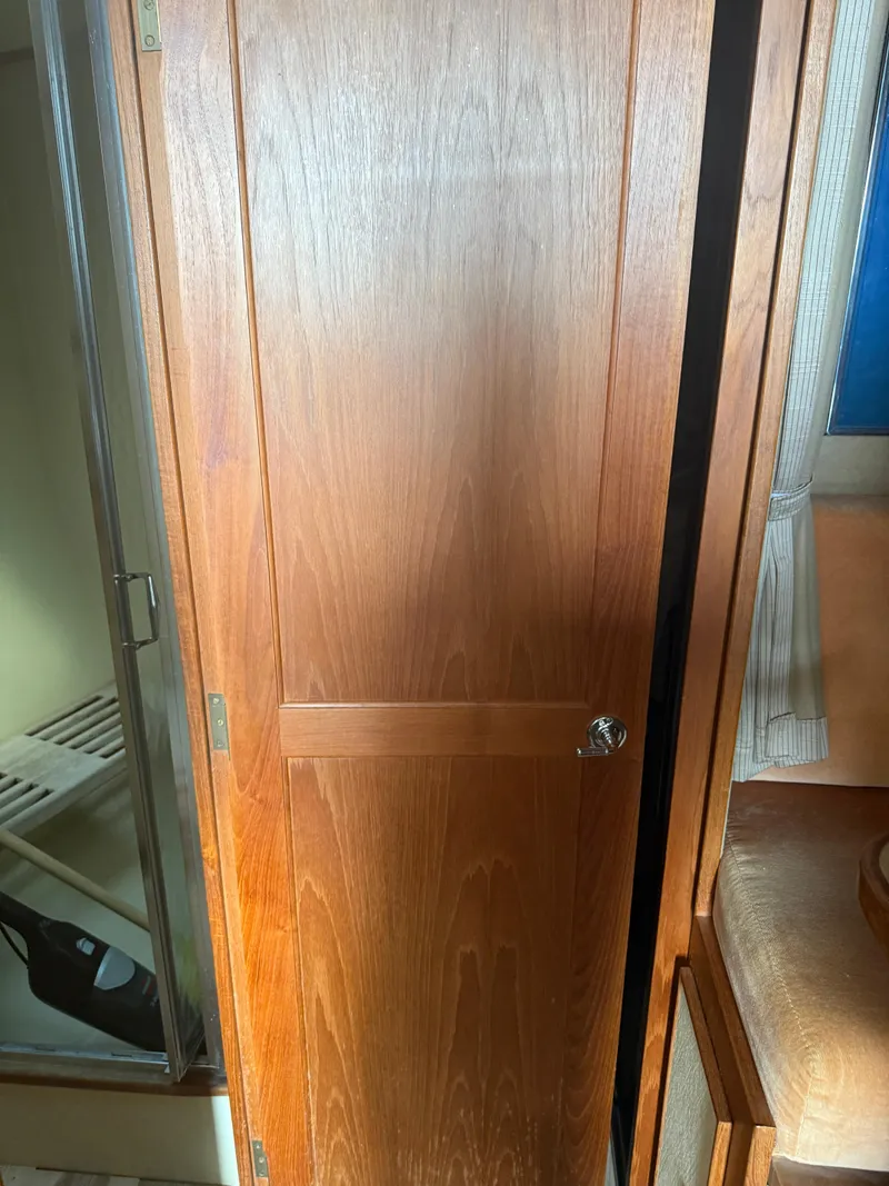 Slide: The Image of Wooden interior door of a 1985 Trojan F36 boat cabin. - 15