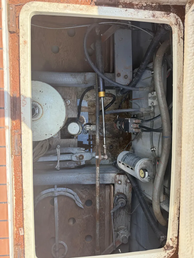 Slide: The Image of Engine compartment of a 1985 Trojan F36 boat, showing mechanical components and wiring. - 16