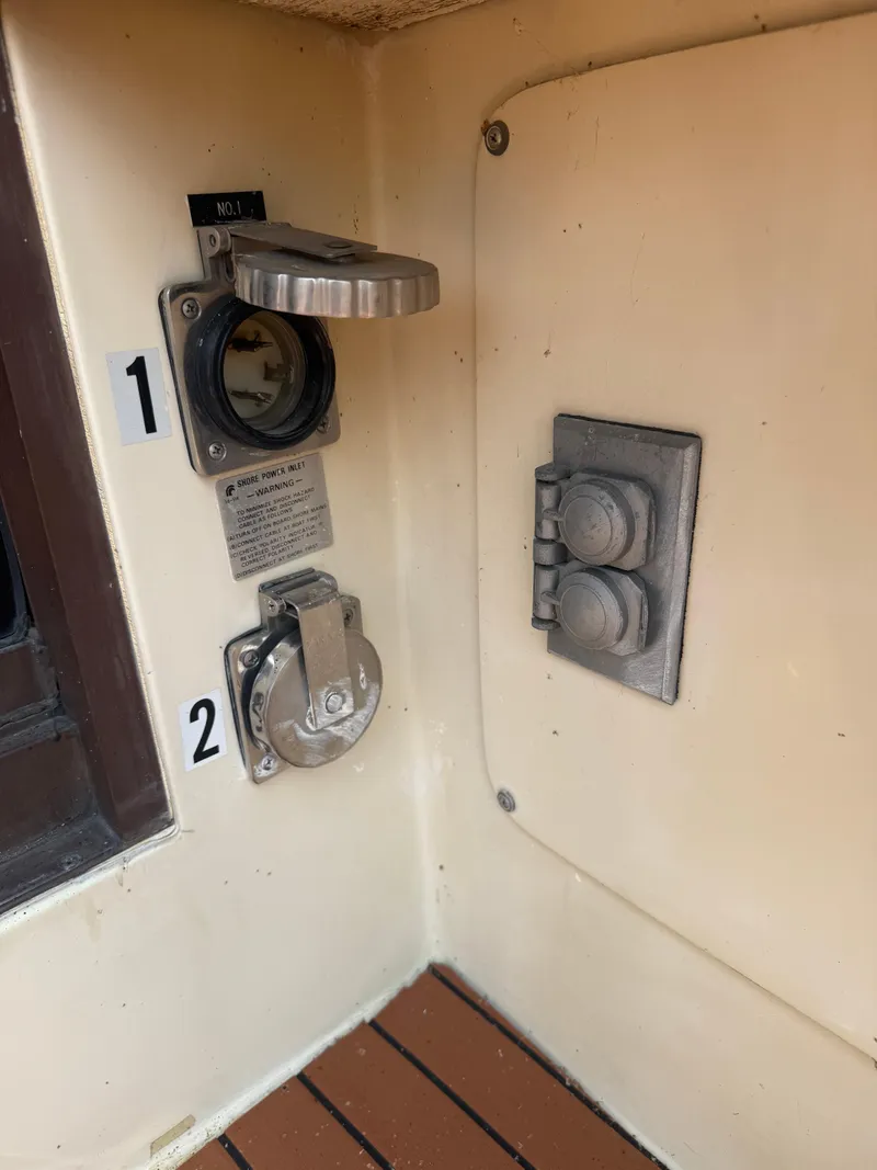 Slide: The Image of 1985 Trojan F36 boat electrical panel with labeled sockets and switches. - 20