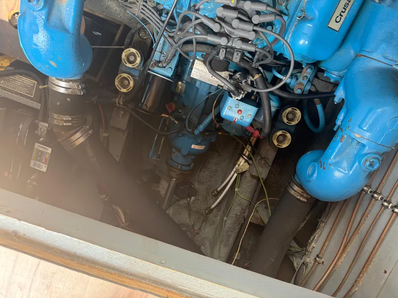 Slide: The Image of Engine compartment of a 1985 Trojan F36 boat, featuring blue components and wiring. - 26