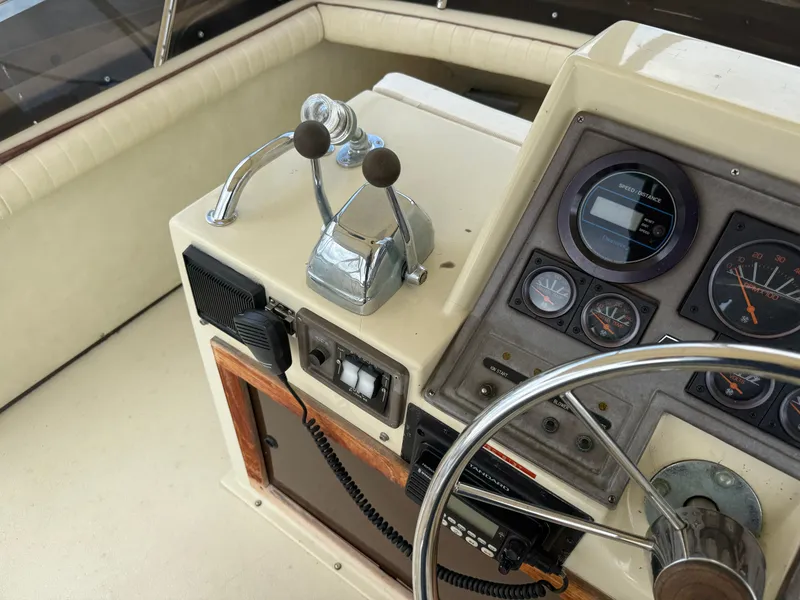 Slide: The Image of Control panel of a 1985 Trojan F36 boat with steering wheel and gauges. - 31