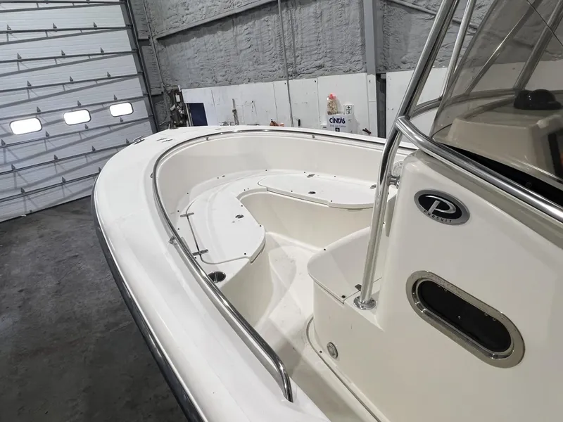 Slide: The Image of 2005 Pursuit 2570 Center Console boat interior in a warehouse setting. - 16