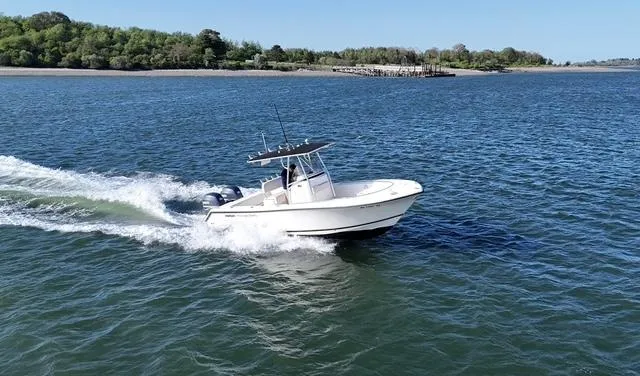 Slide: The Image of 2005 Pursuit 2570 Center Console boat cruising on open water. - 2