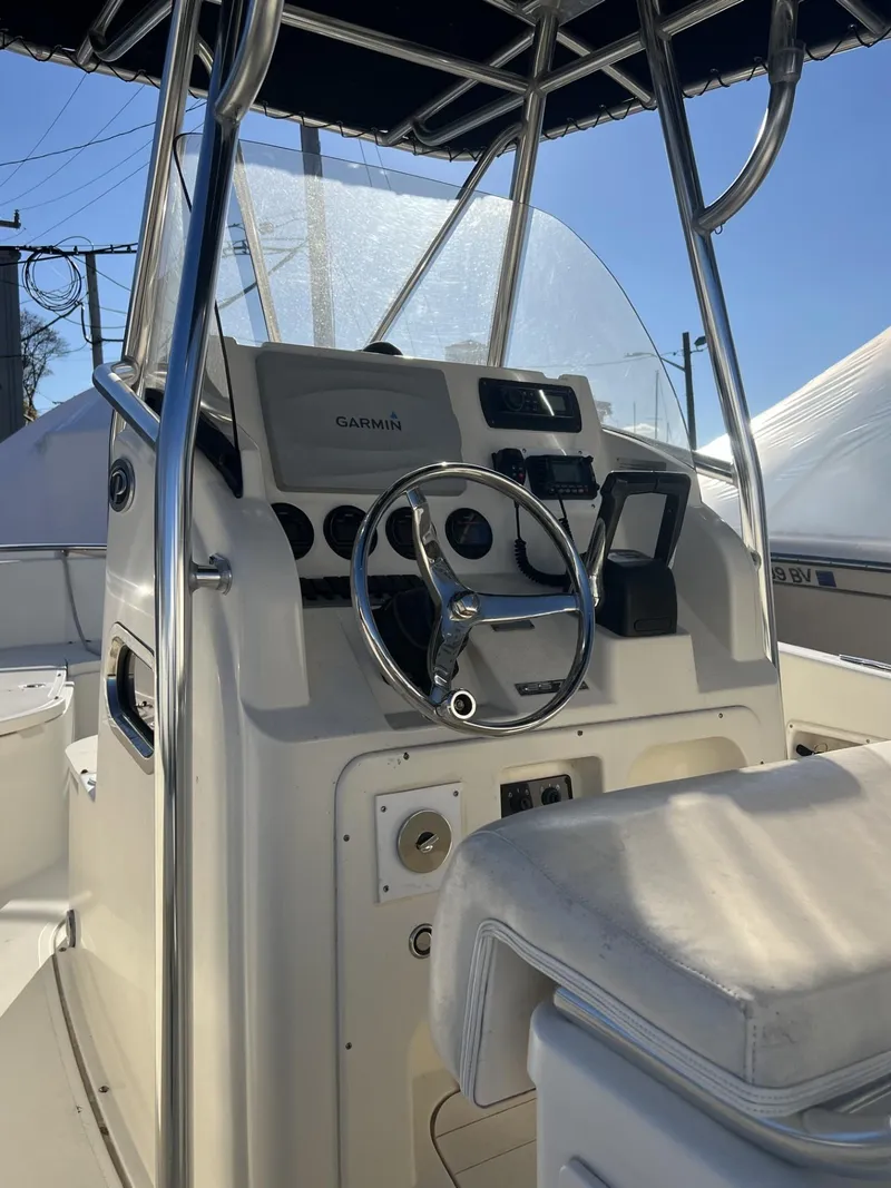 Slide: The Image of 2005 Pursuit 2570 Center Console boat interior with steering wheel and navigation equipment. - 21